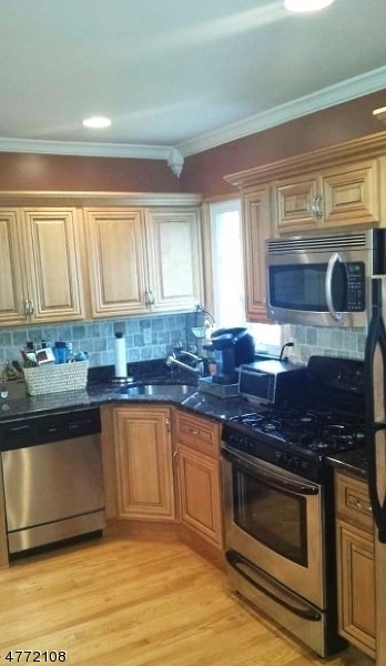 49 Entwistle Avenue, Unit 1 Nutley, NJ 07110 - Photo 2 of 4 a kitchen with stainless steel appliances granite countertop a stove a sink and a microwave