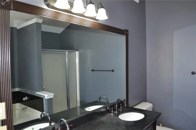 a bathroom with a sink mirror and toilet