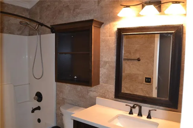 a bathroom with a shower and a sink