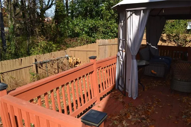 a view of balcony with wooden floor and fence