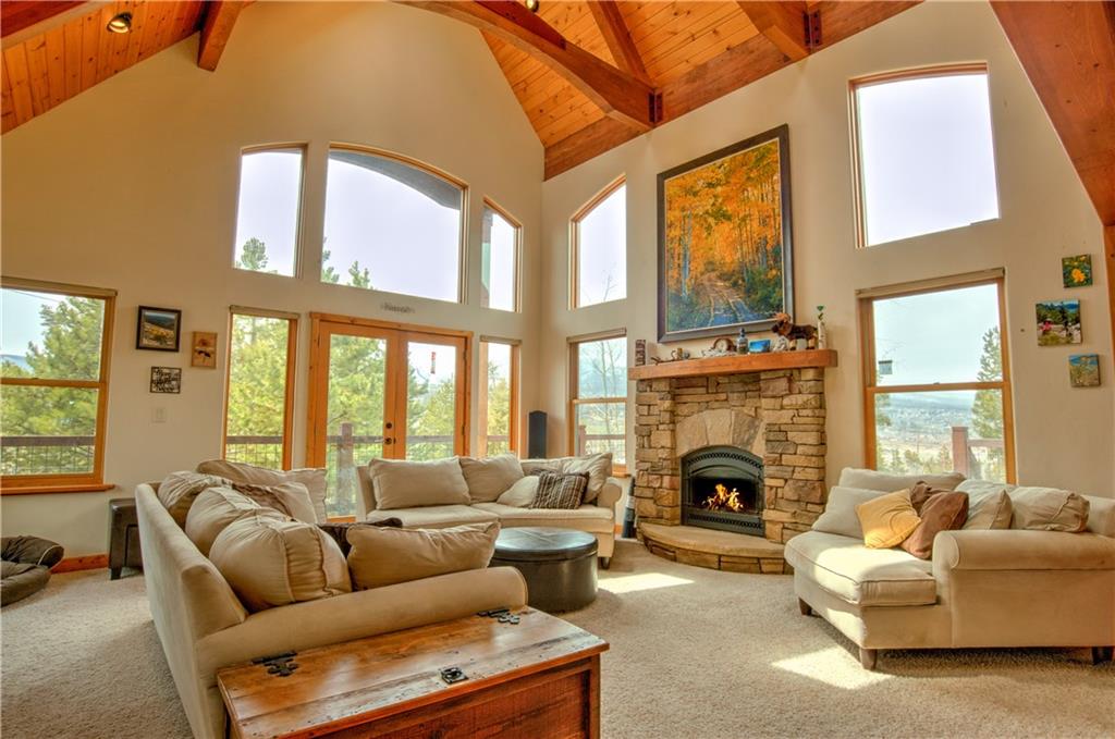 89 N Road Silverthorne, CO 80498 - Photo 1 of 35 a living room with furniture a fireplace and a large window