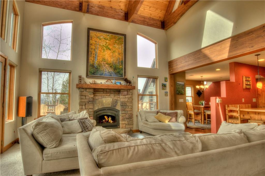 89 N Road Silverthorne, CO 80498 - Photo 2 of 35 a living room with fireplace furniture and a large window
