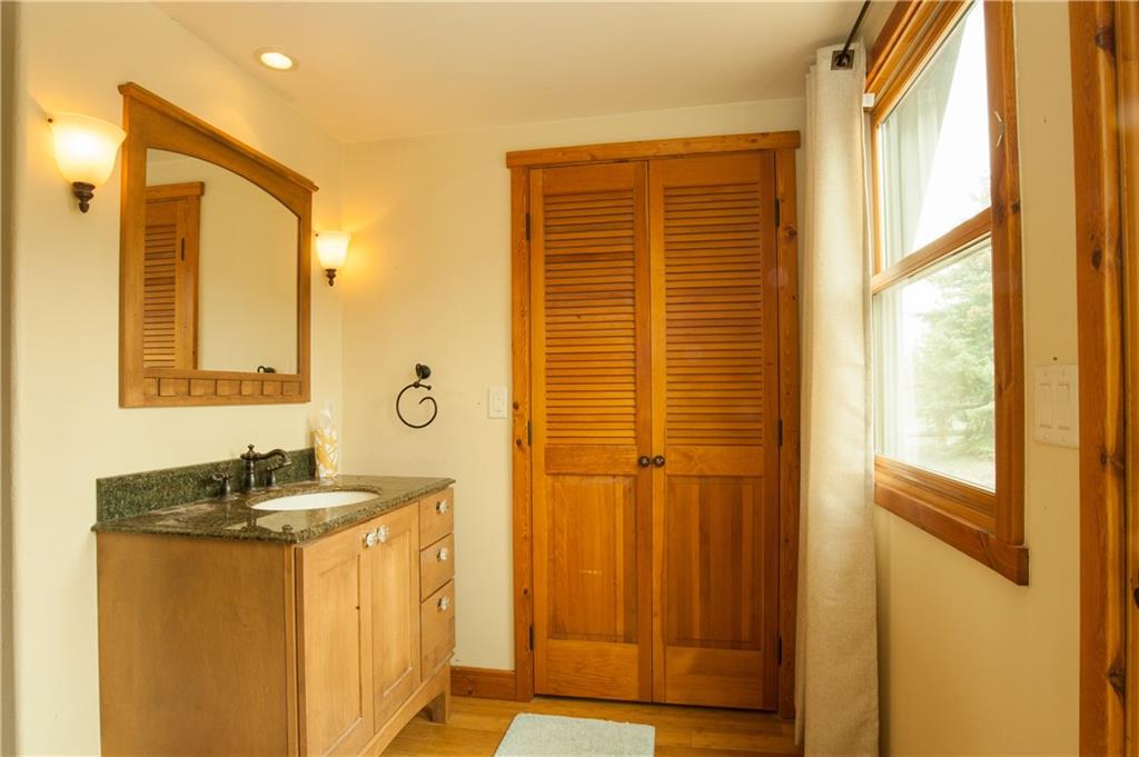 89 N Road Silverthorne, CO 80498 - Photo 12 of 35 a bathroom with a granite countertop sink and a mirror