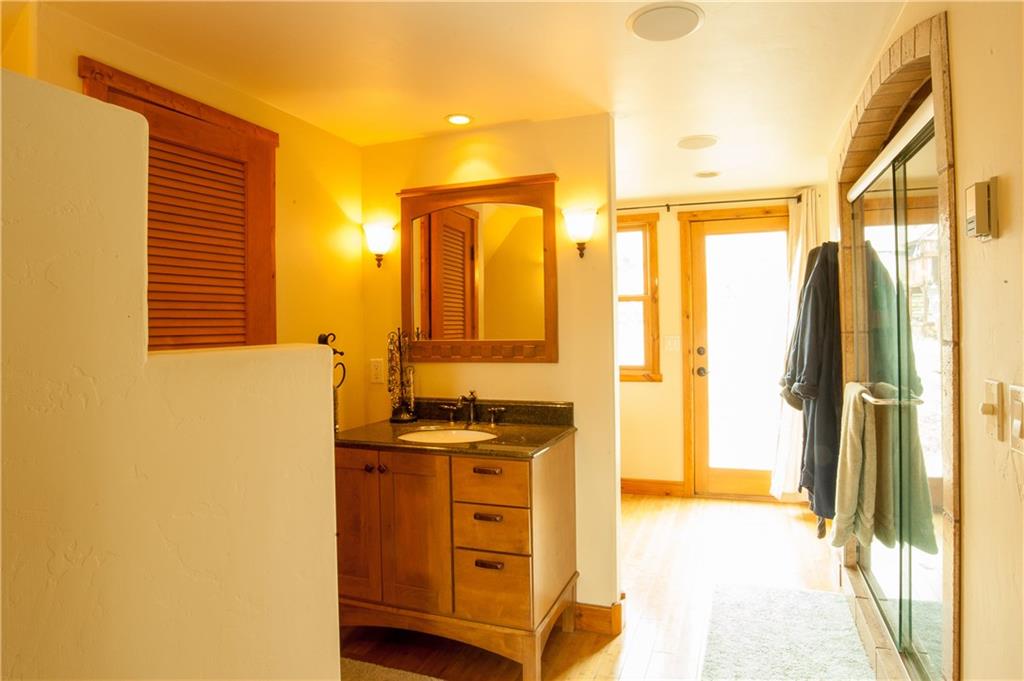 89 N Road Silverthorne, CO 80498 - Photo 14 of 35 a bathroom with a granite countertop sink and a mirror