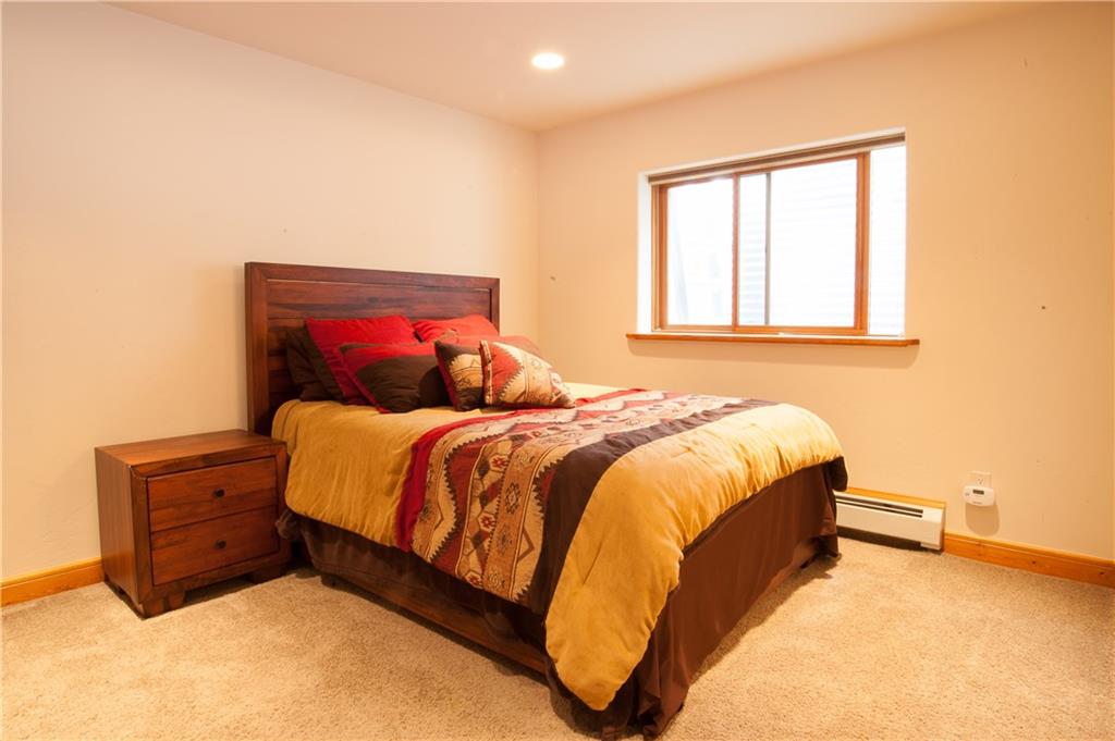 89 N Road Silverthorne, CO 80498 - Photo 18 of 35 a bed sitting in a bedroom next to a window