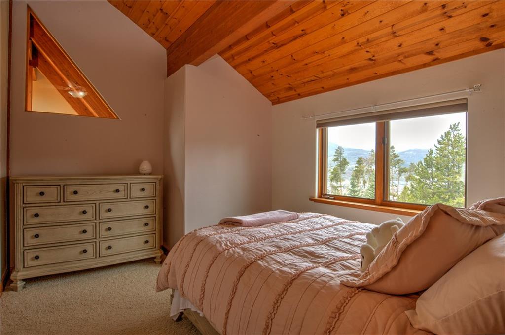 89 N Road Silverthorne, CO 80498 - Photo 23 of 35 a bed sitting in a bedroom next to a window