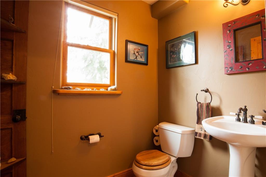 89 N Road Silverthorne, CO 80498 - Photo 27 of 35 a bathroom with a toilet a sink and a window
