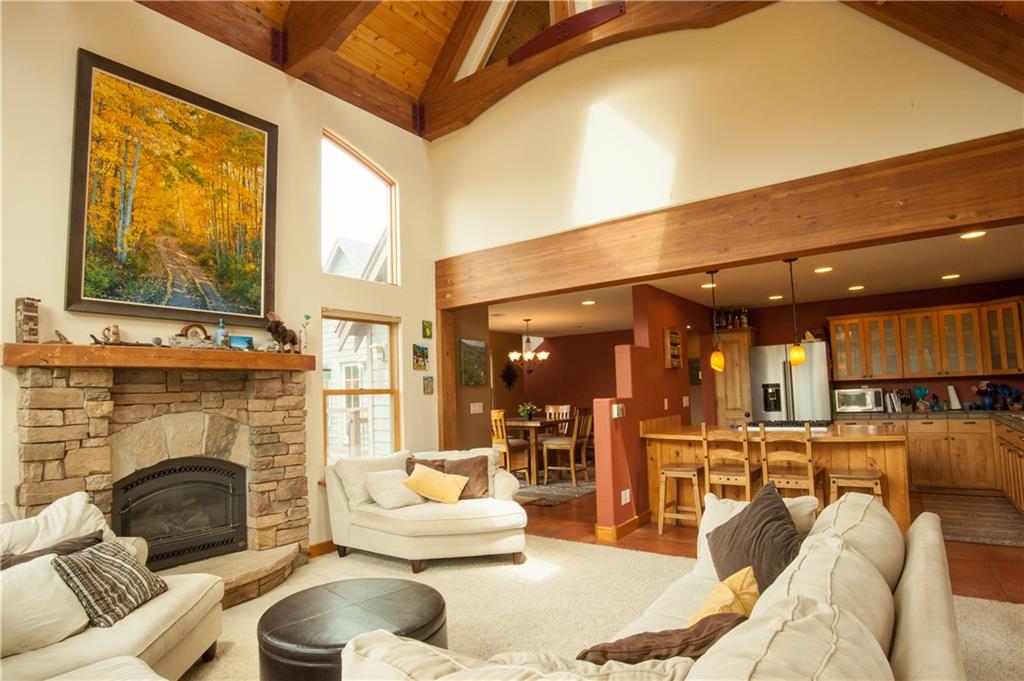 89 N Road Silverthorne, CO 80498 - Photo 4 of 35 a living room with furniture a fireplace and a flat screen tv