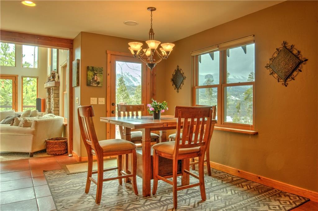 89 N Road Silverthorne, CO 80498 - Photo 9 of 35 a view of a dining room with furniture window and wooden floor