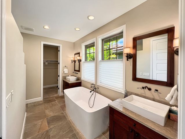 a bathroom with a sink a mirror and a bathtub