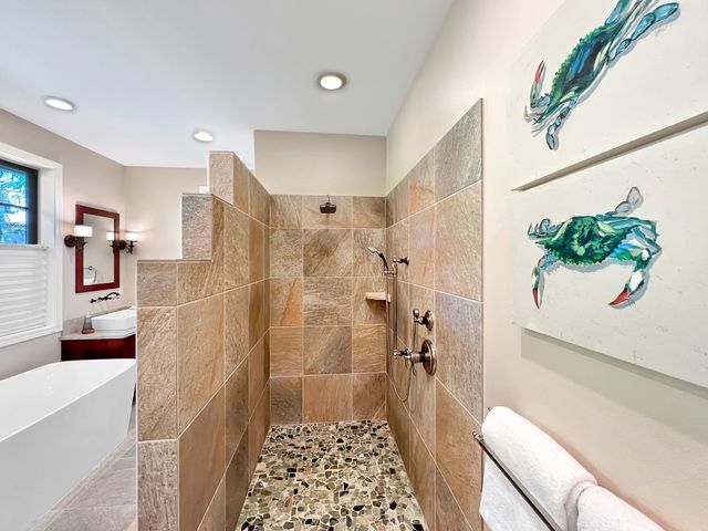 a bathroom with a bathtub and shower