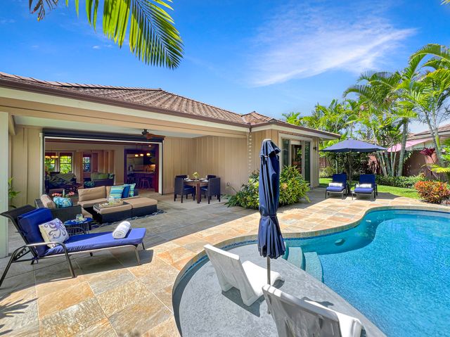 a view of a house with swimming pool and sitting area