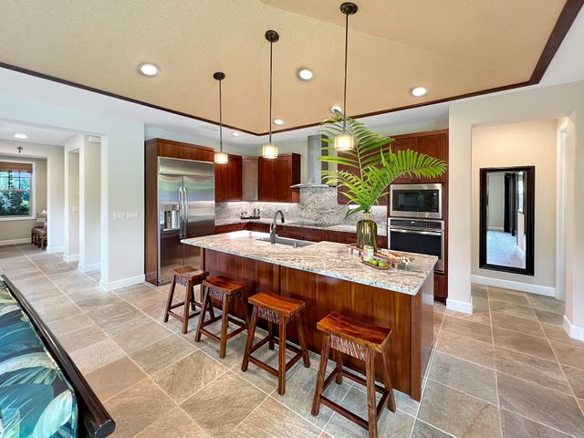 a kitchen with a table chairs and a chandelier