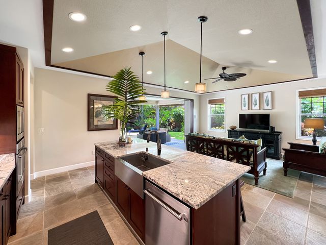 a kitchen with stainless steel appliances granite countertop a sink a stove and a refrigerator