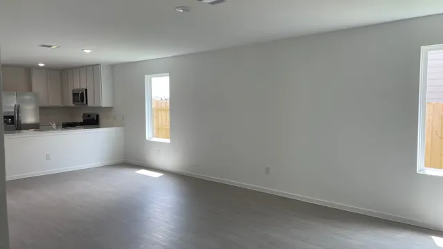 a view of a backyard with plants and wooden fence