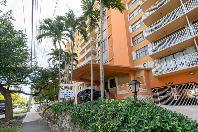 a view of a city with lush green forest