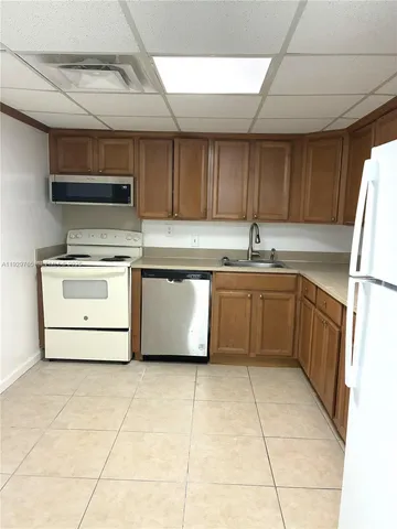 a kitchen with a sink cabinets and appliances