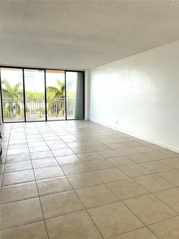 a view of hallway with a bathroom and a shower