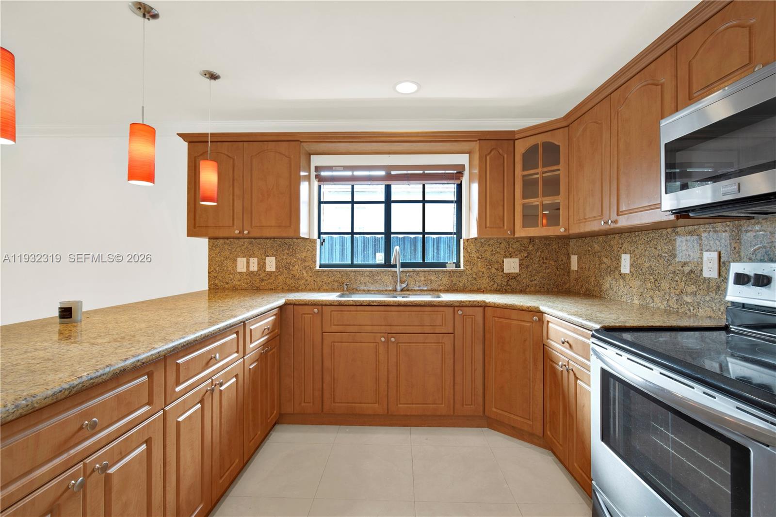 2237 Southwest 63rd Avenue Miami, FL 33155 - Photo 11 of 28 a kitchen with stainless steel appliances granite countertop a sink stove and microwave