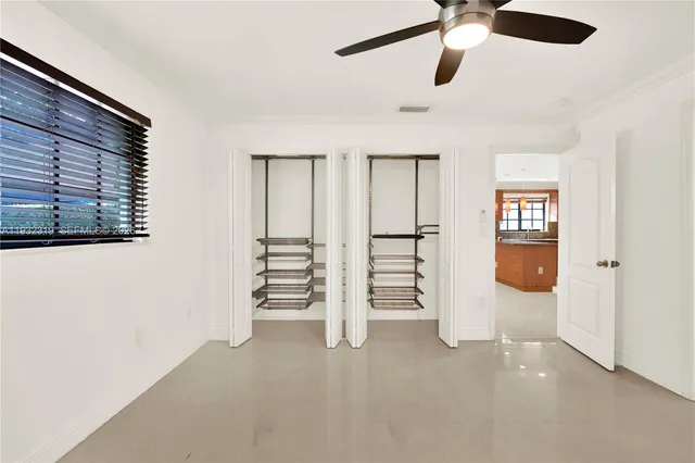 an empty room with windows and closet