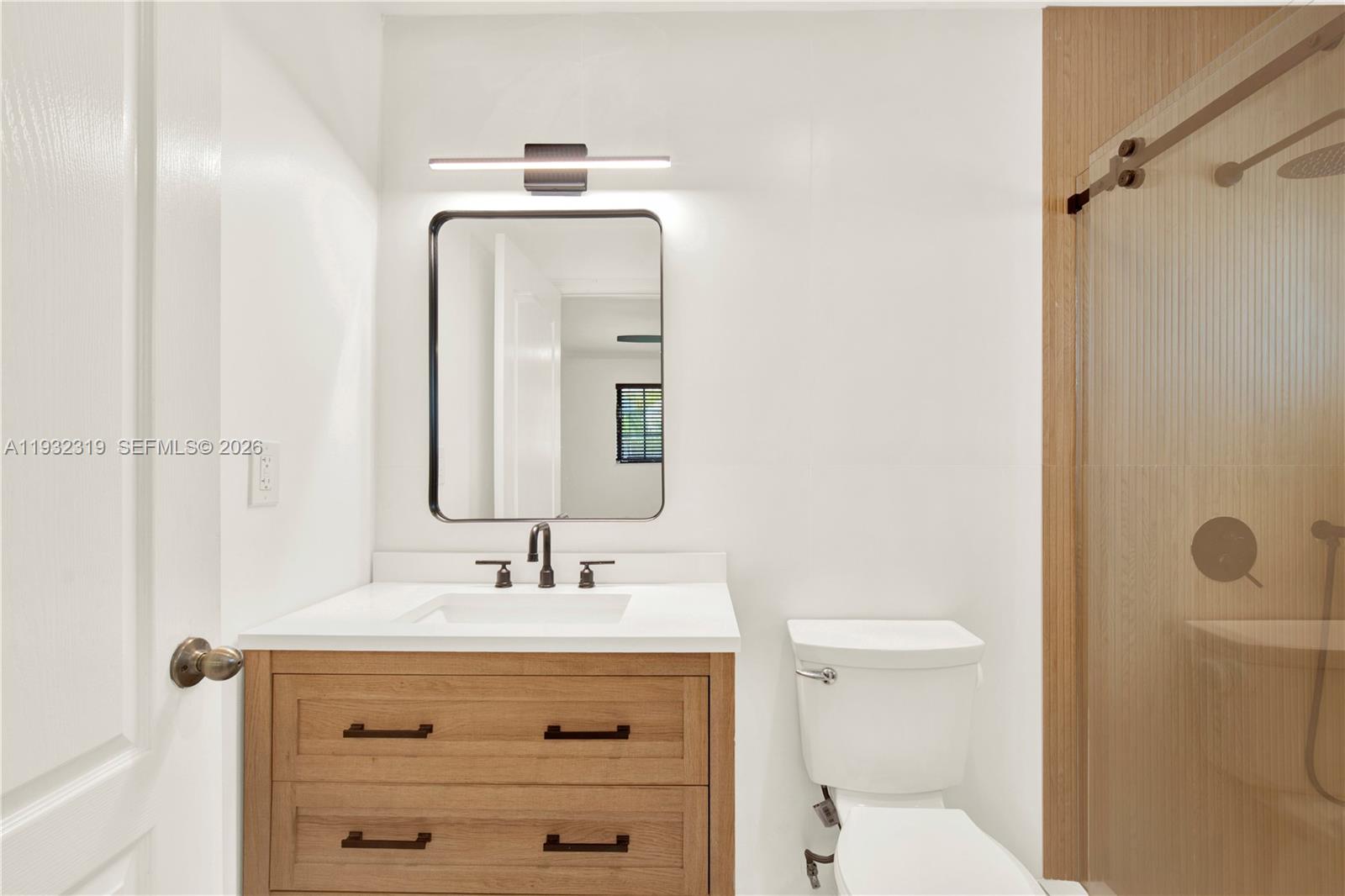 2237 Southwest 63rd Avenue Miami, FL 33155 - Photo 18 of 28 a bathroom with a sink a toilet and shower