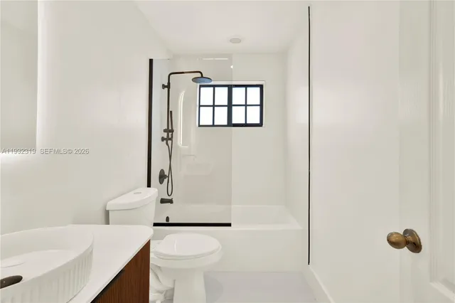 a bathroom with a toilet a sink and a bathtub
