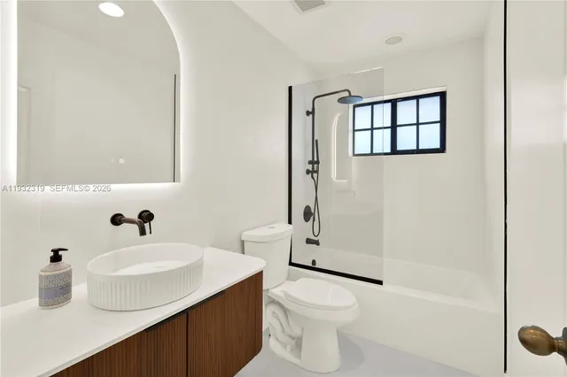 a bathroom with a sink toilet and shower