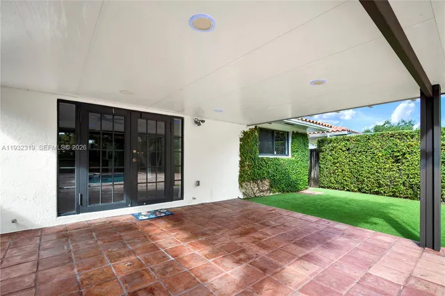 a view of a house with backyard and porch