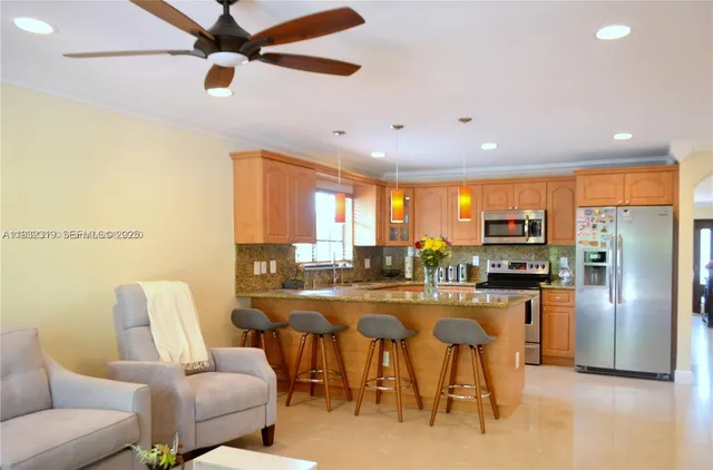a dining room with furniture and a kitchen view