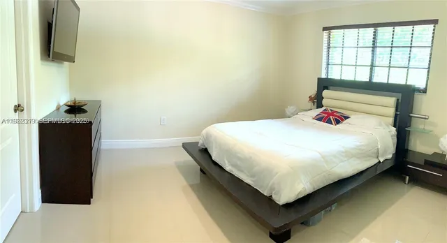 a bedroom with a bed and window