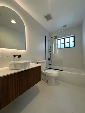 a bathroom with a sink a toilet and a tub