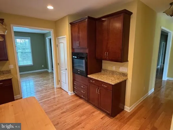a kitchen with a stove and a wooden cabinets