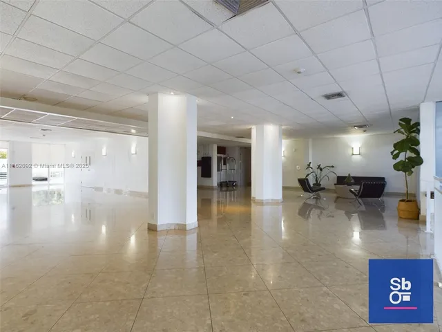 a lobby with furniture and a potted plant