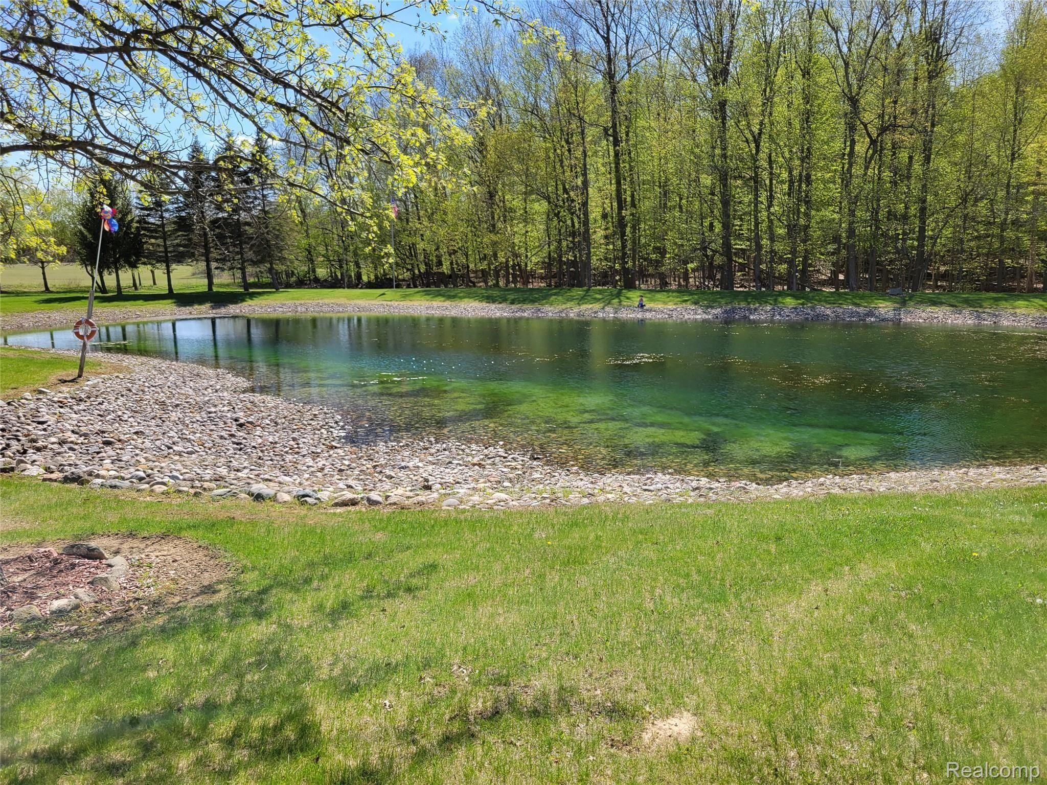 567 North Summers Road Imlay City, MI 48444 - Photo 21 of 77 Pond is landscaped with stone perimeter.