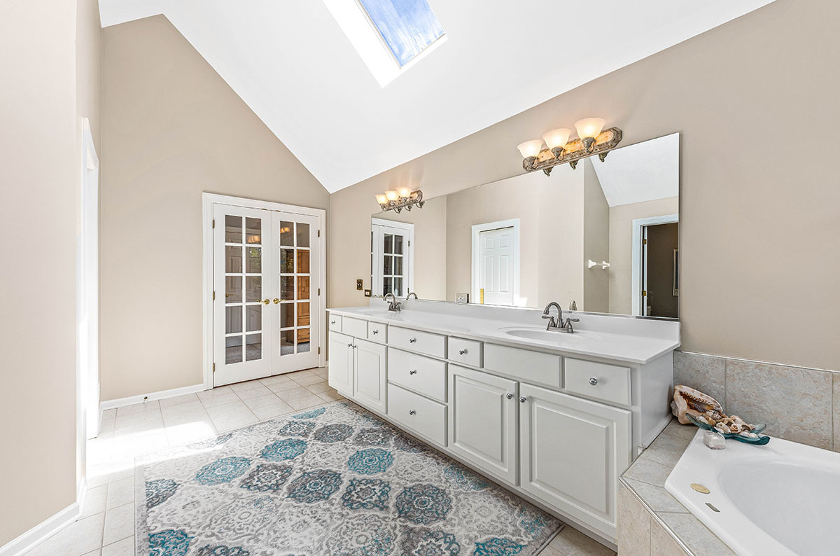 4435 Esquire Circle Naperville, IL 60564 - Photo 21 of 45 a spacious bathroom with a double vanity sink a mirror a bathtub and