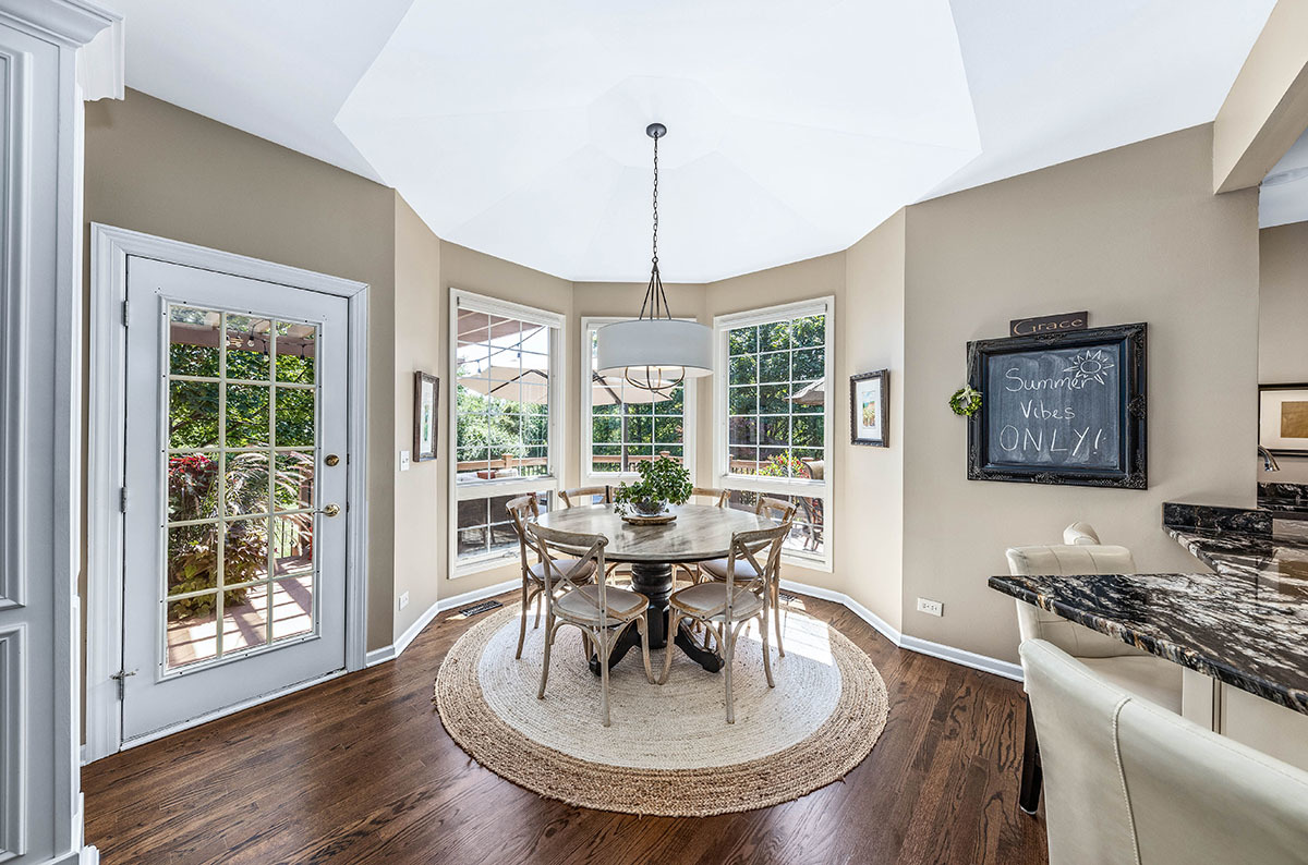4435 Esquire Circle Naperville, IL 60564 - Photo 8 of 45 a dining room with furniture a chandelier and wooden floor