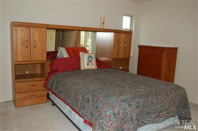 202 El Prado Avenue San Rafael, CA 94903 - Photo 3 of 5 a bedroom with a large bed and a dresser