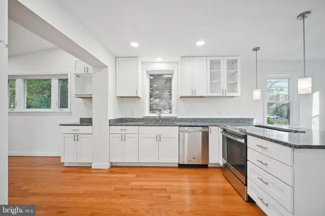 a kitchen with stainless steel appliances granite countertop a sink and cabinets