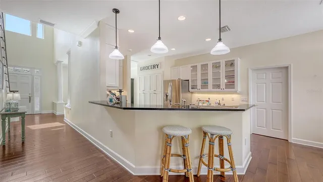 a kitchen with stainless steel appliances a stove a refrigerator and cabinets