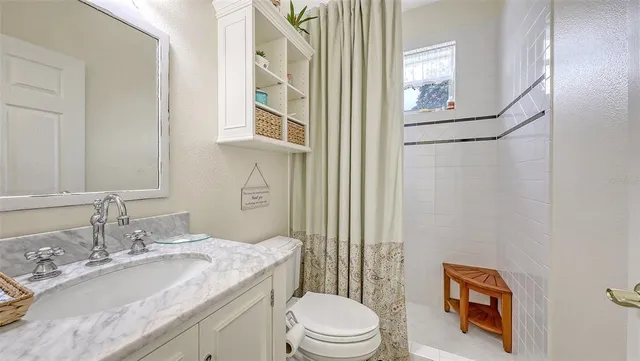 a view of a patio with table and chairs and potted plants