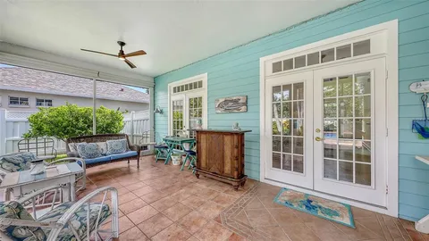 a view of a chair and table in backyard of the house