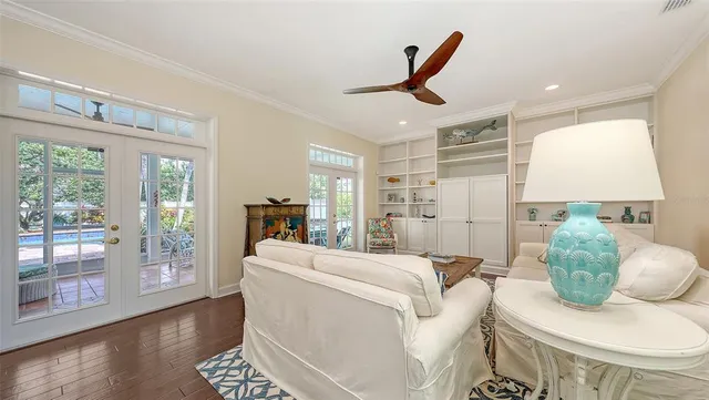 a kitchen with stainless steel appliances granite countertop a stove a sink dishwasher a refrigerator white cabinets and wooden floor