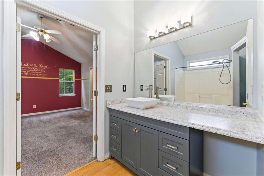 6581 Coventry Point Austell, GA 30168 - Photo 17 of 20 a bathroom with a granite countertop sink and a mirror