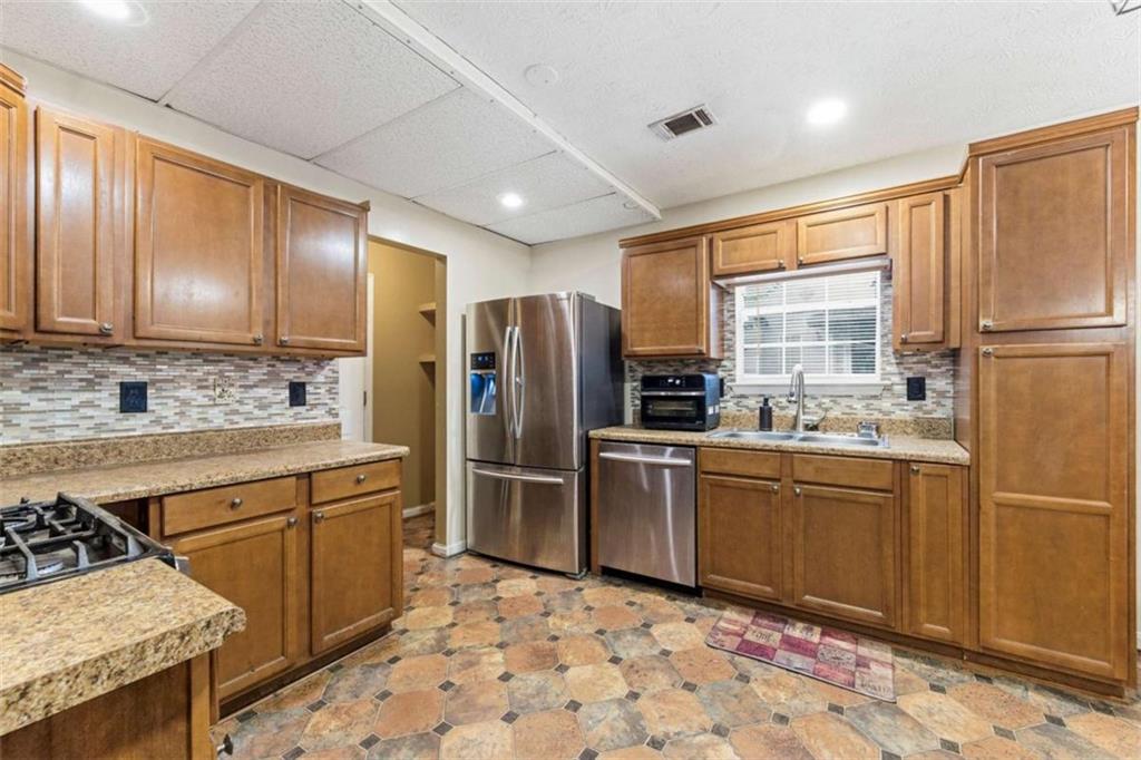 6581 Coventry Point Austell, GA 30168 - Photo 7 of 20 a kitchen with stainless steel appliances granite countertop a refrigerator a stove a sink and a refrigerator