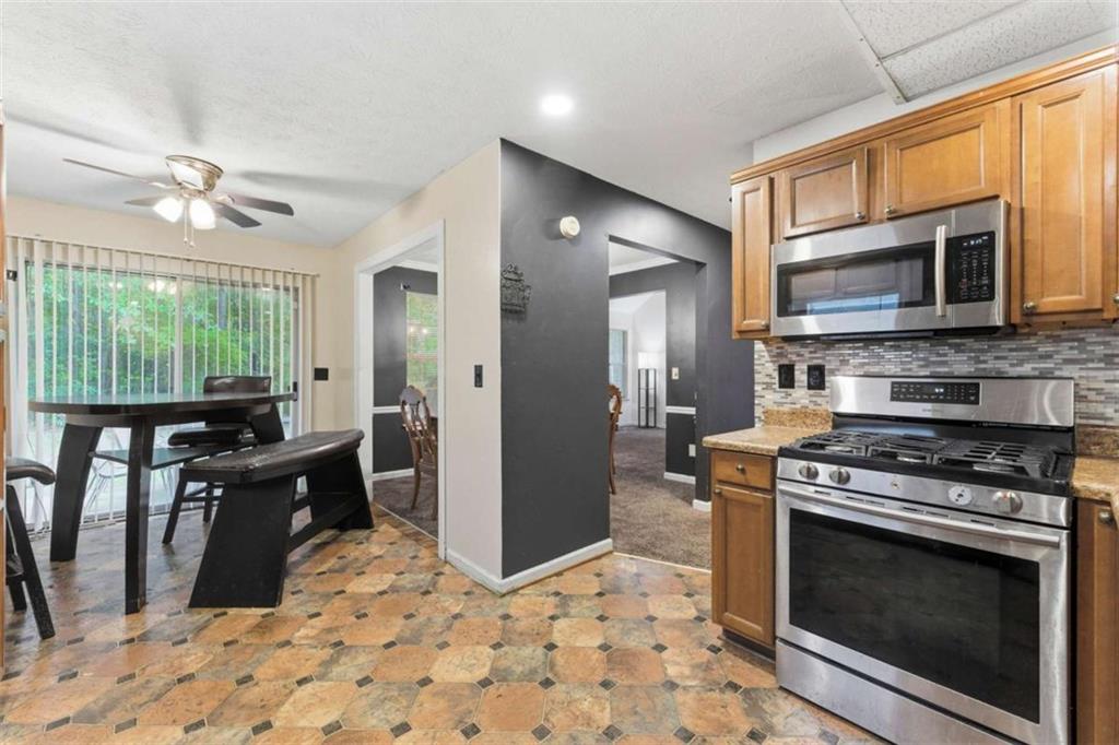 6581 Coventry Point Austell, GA 30168 - Photo 8 of 20 a kitchen with stainless steel appliances granite countertop a stove a refrigerator and a microwave