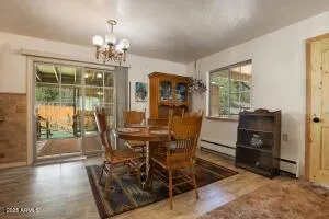 a view of a dining room with furniture a chandelier and wooden floor