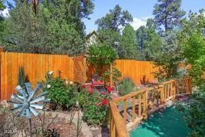 a view of a chair and table in backyard of the house