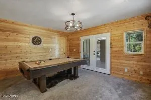 a room with pool table and windows