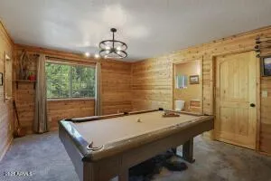 a room with pool table and windows