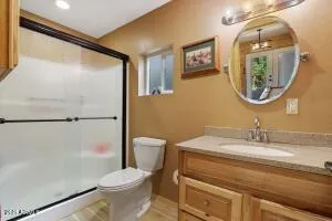 a bathroom with a toilet a sink and a mirror